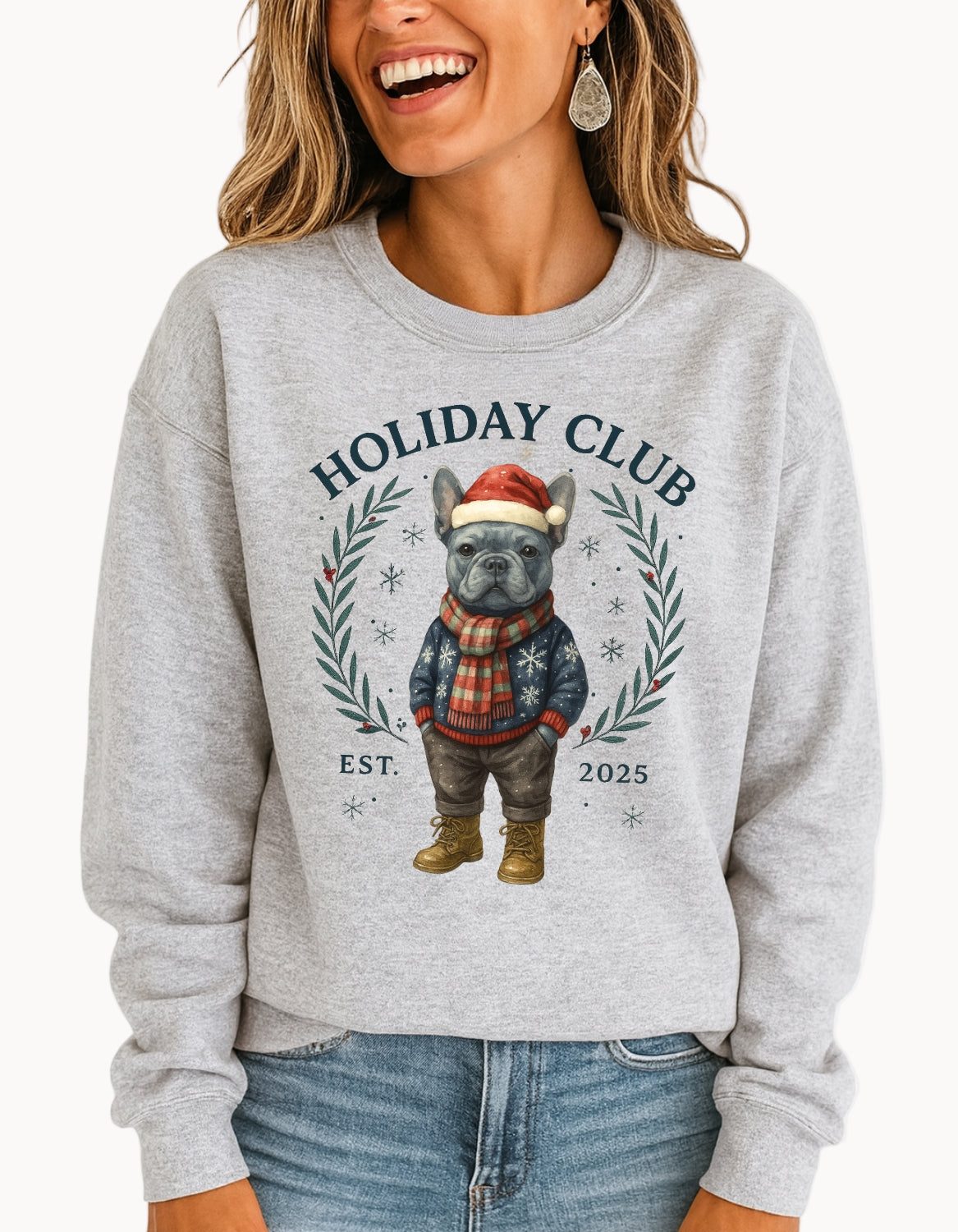 Person wearing a gray sweatshirt with a 'Holiday Club' design featuring a dog in winter clothing.