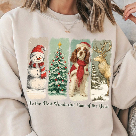 Person wearing a beige sweatshirt with Christmas-themed graphics and text.