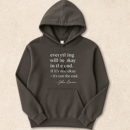 Dark gray hoodie with a quote on a beige background