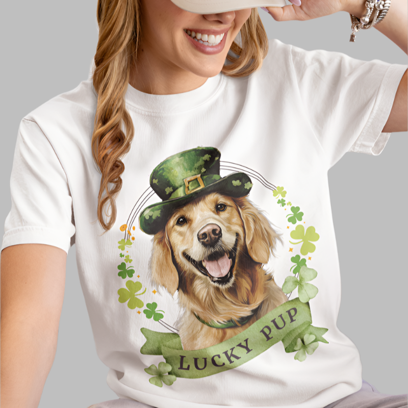 woman wearing white St. Patrick’s Day t-shirt featuring a golden retriever dog with a shamrock garland and festive Irish designan 