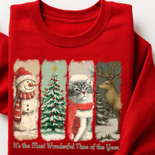 Red sweatshirt with Christmas-themed design featuring a snowman, tree, cat, and deer on a white background.