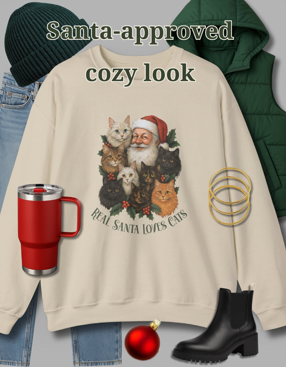 Beige sweatshirt with Santa and cats design, red mug, green beanie, and black boots on a light gray background.