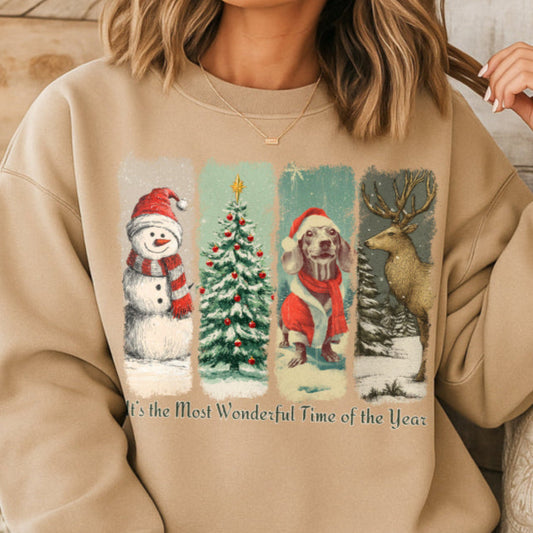 Person wearing a sand sweatshirt with Christmas-themed graphics and text.