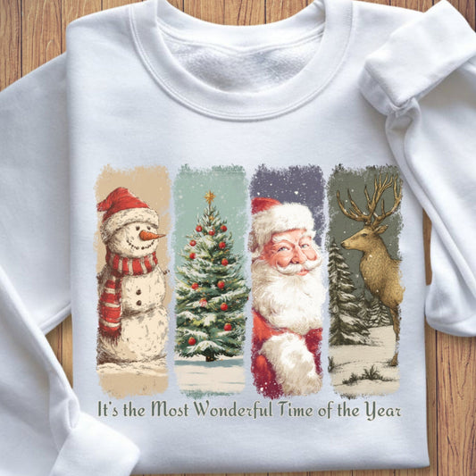 White sweatshirt with vintage Christmas-themed design featuring Santa Claus, a snowman, a tree, and a reindeer on a wooden surface.