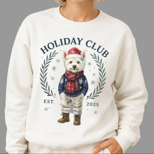 Woman wearing a white sweatshirt with a holiday-themed design in front of a decorated Christmas tree.