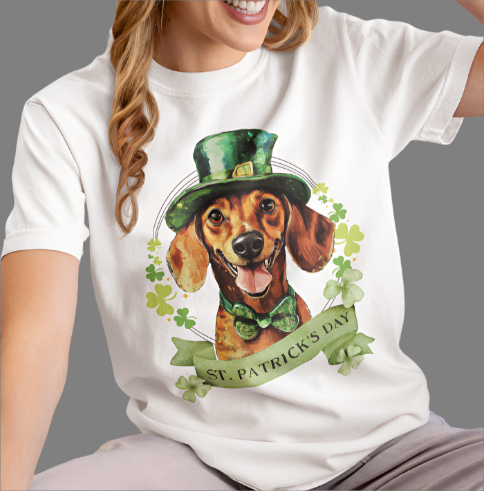 woman in white St. Patrick’s Day t-shirt featuring a Dachshund dog with a shamrock garland and festive Irish design