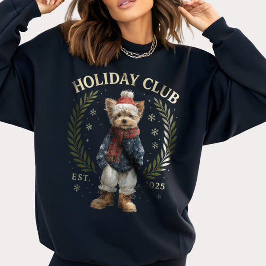 Person wearing a navy blue sweatshirt with 'Holiday Club' design featuring a dog in winter attire.