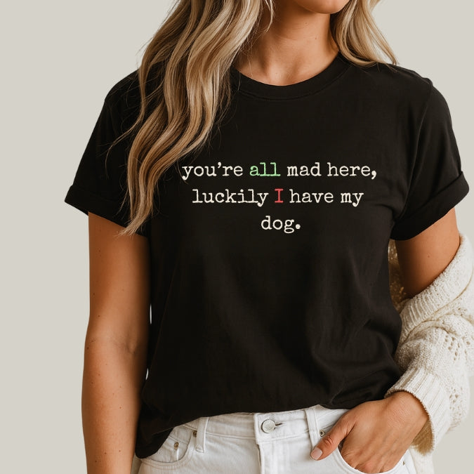 Person wearing a black t-shirt with a humorous quote on a plain background